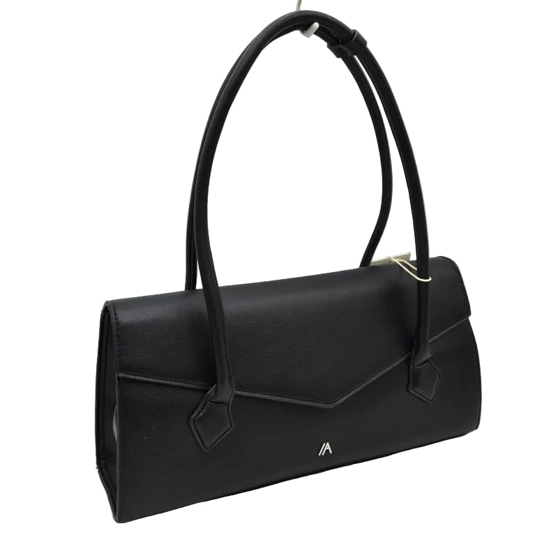 A black leather handbag with a structured envelope-style body, dual top handles, a flap closure, and a small gold logo on the front, photographed against a light gray studio background.