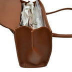 A brown leather tote bag shown open, revealing white tissue paper and clear plastic wrapping inside, on a plain white background.