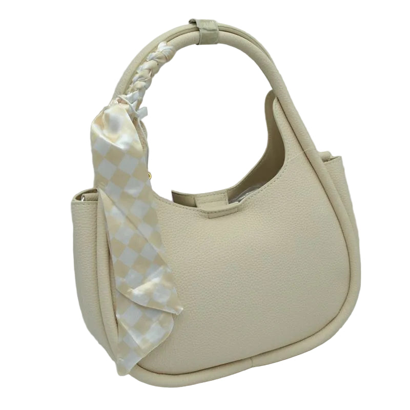 Beige handbag with a decorative bow on a white background