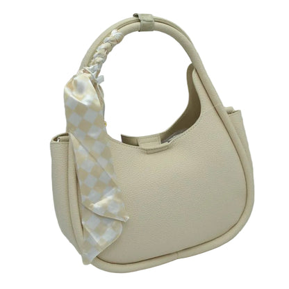 Beige handbag with a decorative bow on a white background