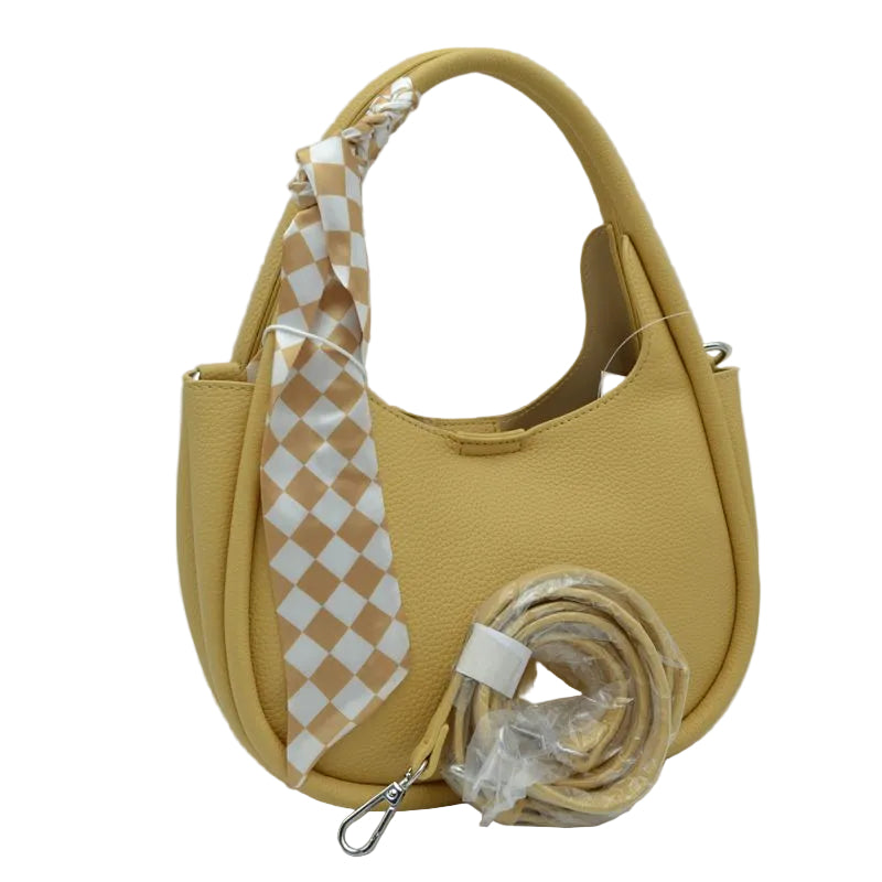 A mustard yellow pebbled leather shoulder bag with a matching yellow strap and a beige-and-white checkered scarf, shown on a white background.
