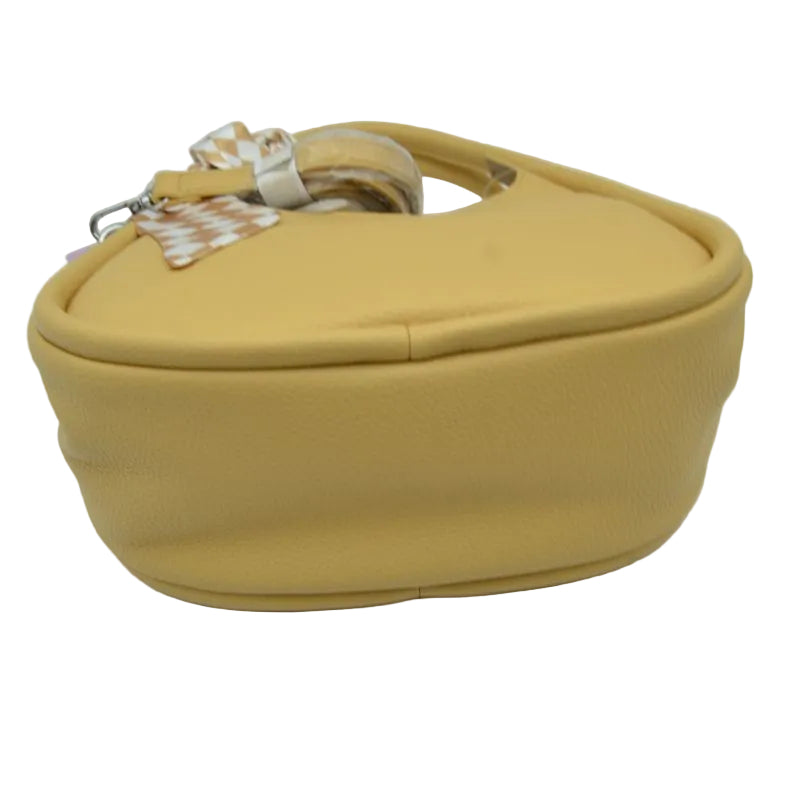 A mustard yellow textured faux-leather handbag with a matching top handle and a decorative patterned ribbon accent, shown on a plain white background.