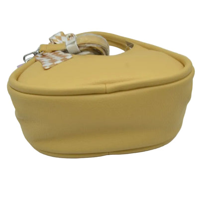 A mustard yellow textured faux-leather handbag with a matching top handle and a decorative patterned ribbon accent, shown on a plain white background.
